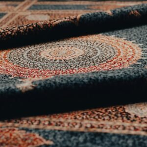 Rolled-up rug shows intricate pattern and detail.